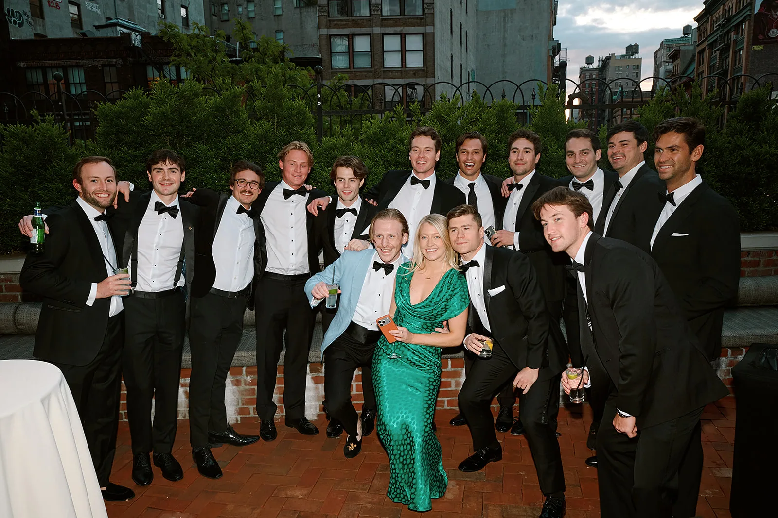 A crowd of guests together in black tie.